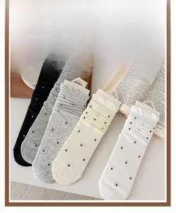 Detail view of four-color ruffled ankle socks with classic polka dots and ribbed knit texture