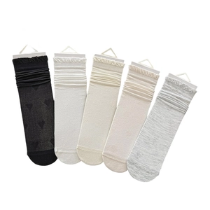 Five pairs of silk mesh heart pattern crew socks with ruffle cuffs in neutral tones