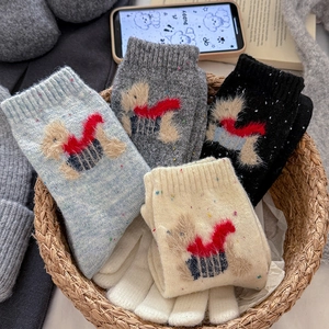 Set of four wool blend puppy socks with faux fur accents and matching gloves in a basket