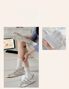 Close-up of breathable white ribbed crew socks paired with vintage silver sneakers