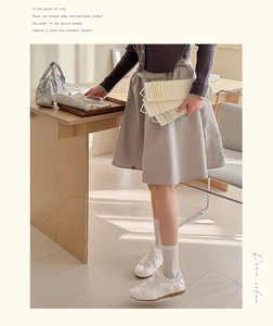 Close-up of white silk bow mesh socks paired with sneakers in a cozy lifestyle setting