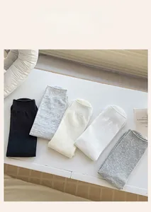 Detail of five assorted solid color cotton mid-calf socks with ribbed elastic cuffs