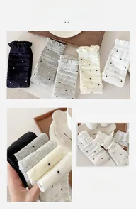 Detail of polka dot socks with ruffled edges in black, grey, cream and white colors
