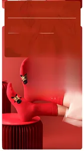 Detail showing red cotton crew socks with gold Ping An embroidery and cartoon character