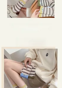 Close-up of striped cotton socks with 'sweet!!' label and contrasting ribbed cuff details