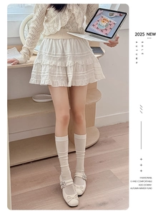 White slouch socks styled with tiered ruffle skirt and bow Mary Jane shoes
