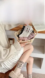 Detailed knit of vintage Fair Isle wool socks with floral patterns in a woven basket