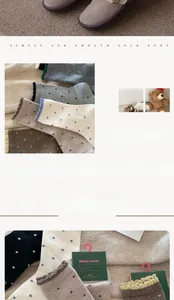 Detailed view of winter wool socks with polka dots and delicate wavy edges in earth tones