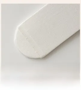 Close-up of seamless white silk knit toe with high-quality flat stitched seams