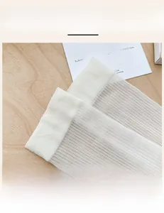Detail of white sheer mesh socks featuring high-elastic ribbed cuffs for a perfect fit