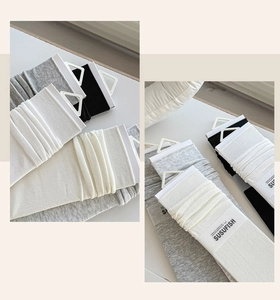 Detailed view of knitted slouch socks in neutral tones with minimalist packaging
