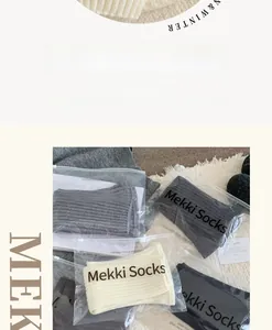 Detailed view of multi-color ribbed knit leg warmers in individual zipper packaging