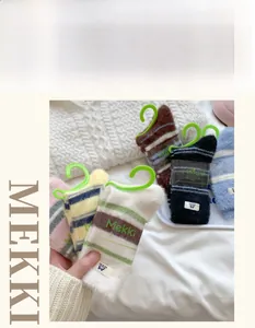 Detail of plush striped mink cashmere socks in multiple colors with woven brand labels