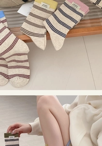 Detailed view of striped cotton blend crew socks with colorful ribbed cuffs and fabric labels