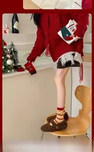 Detailed knit texture of Christmas socks featuring festive Santa and tree patterns