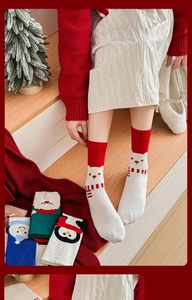 Christmas cartoon cotton socks featuring polar bear and santa claus in a cozy holiday setting