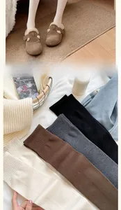 Close-up of knit over-the-knee socks in various colors with soft warm winter texture