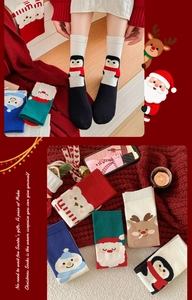 Detail of Christmas cotton socks featuring festive penguin, snowman and reindeer patterns
