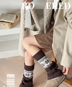 Detailed knit texture of vintage Fair Isle leg warmers with elk and snowflake patterns