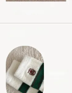 Close-up of high-elasticity ribbed cuffs on striped winter socks with teddy bear embroidery