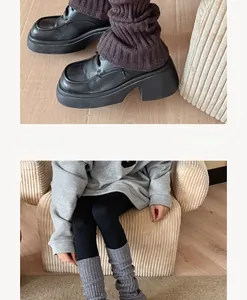 Detailed knit texture of vertical ribbed leg warmers in brown and grey tones