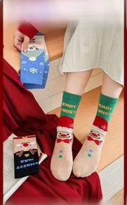 Close-up of festive Christmas cotton socks featuring Santa Claus and reindeer patterns