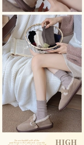 Close-up of cozy wool socks and suede loafers with warm lamb wool lining for winter