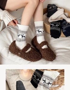 Detail of wool socks with Fair Isle reindeer pattern and plush Mary Jane shoes