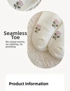 Close-up of seamless toe stitching on beige cashmere socks with floral embroidery