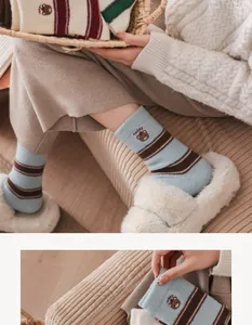 Close-up of winter thermal striped socks featuring a cute Teddy bear patch and soft knit texture