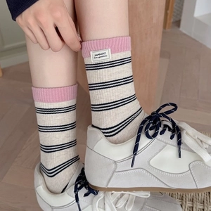 Japanese style striped crew socks in creamy white with pink ribbed cuffs and label