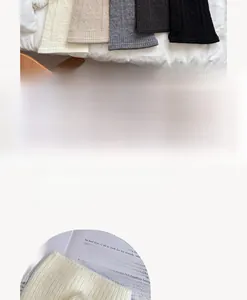 Macro view of ribbed knit leg warmers in white, beige, grey, and black wool blend
