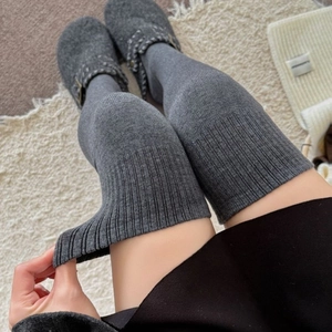 Thick knitted dark grey over-knee socks featuring ribbed cuffs for winter warmth
