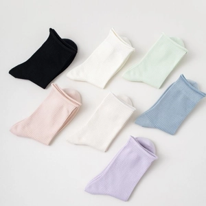 Set of seven colorful ribbed cotton socks with rolled edges in diverse soft pastel tones