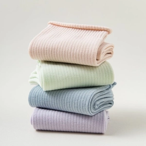 Stack of women's pastel cotton crew socks in pink, green, blue, and purple colors