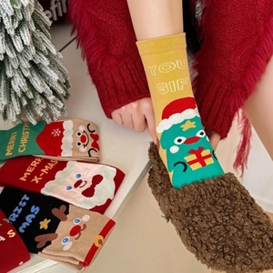 Cozy Christmas themed mid-calf cotton socks with Santa and reindeer patterns for women
