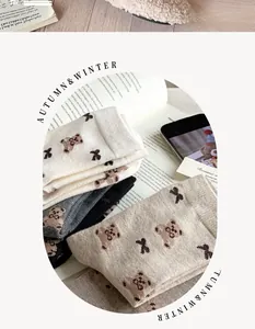 Detailed knit of warm autumn socks with cute bear and bow jacquard patterns