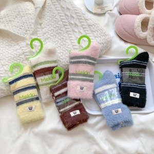 Warm winter fuzzy socks in striped faux mink fur with various pastel colors for home wear