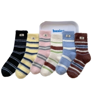 Set of six colorful striped mink velvet socks with cat labels in a white tray