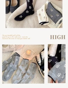 Detailed view of floral pattern and wavy cuffs on soft cashmere wool blend socks
