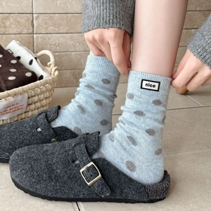 Polka dot crew socks for women with felt slippers in a cozy home setting for winter