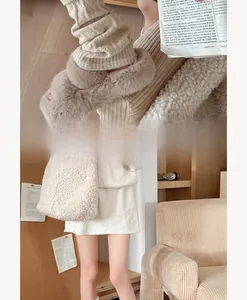 Winter ballet style white ribbed knit leg warmers paired with plush slippers and bag