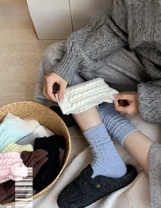 Detail of colorful chunky cable knit wool socks for winter home wear and comfort