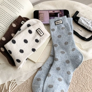 Three pairs of warm polka dot knit socks in brown, off-white and blue for winter