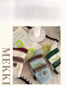 Gros plan de chaussettes d'hiver épaisses avec broderie animale et motifs à rayures