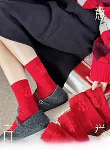 Detail of red Year of the Horse socks featuring traditional Chinese lucky embroidery