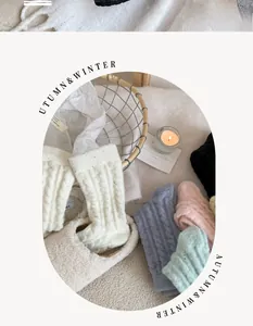 Detailed macro view of thick cable knit thermal socks in soft pastel color palettes