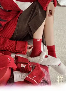 Gros plan détaillé de chaussettes rouges festives avec dentelle et étiquettes brodées