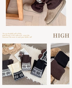 Detail of warm Fair Isle leg warmers with snowflake patterns in gray and brown