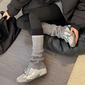 Grey and black color-block ribbed knit leg warmers with flared fit for leg shaping